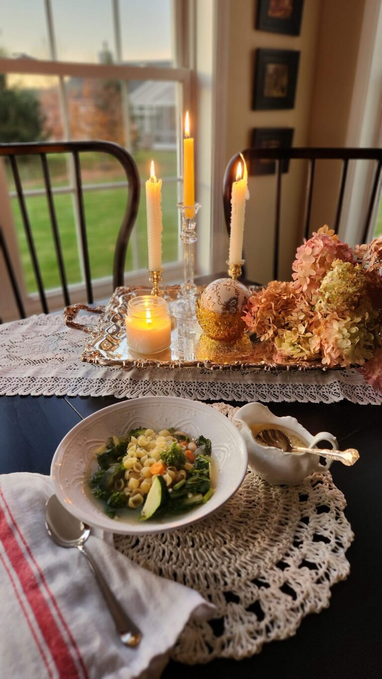dinner table with candles and minestrone soup bowl