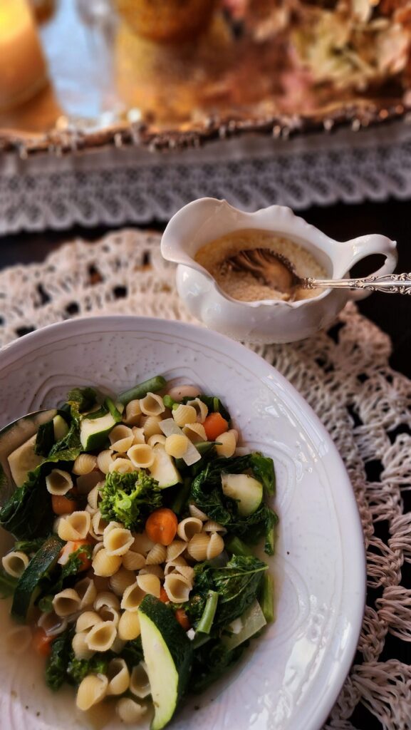 bowl of minestrone soup with grated cheese in white creamer