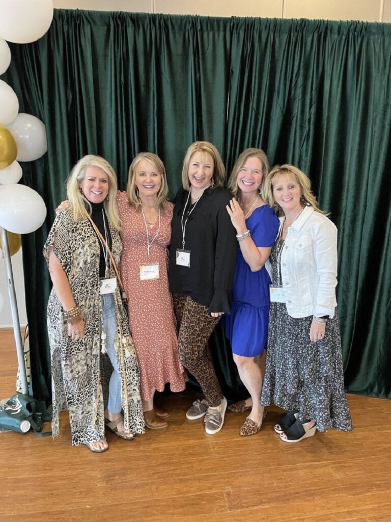 five ladies at a conference