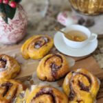 pumpkin buns on tale with white teacup and tea