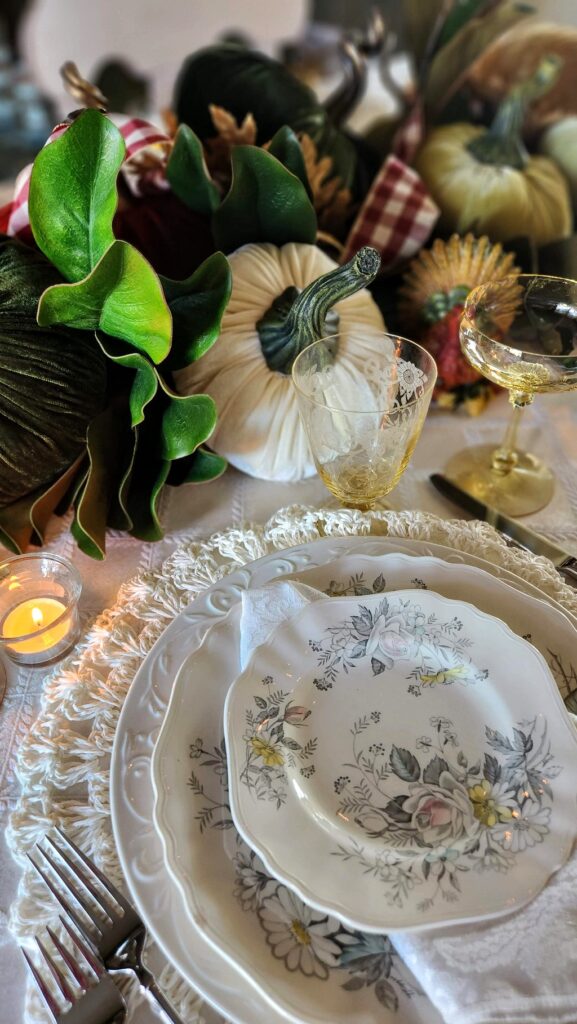 white dishes with velvet pumpkins on thanksgiving table