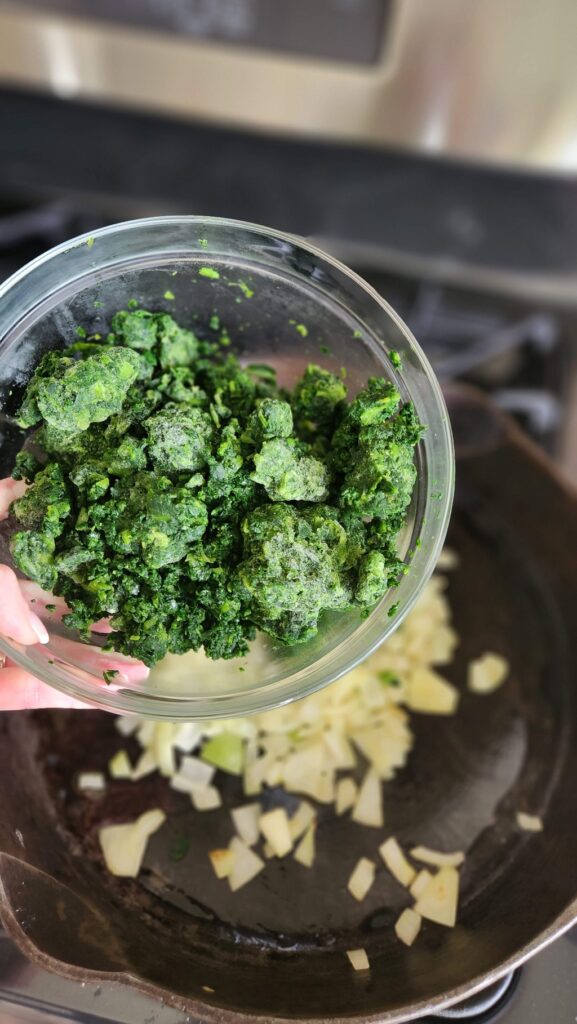 frozen spinach in glass bowl over frying pan
