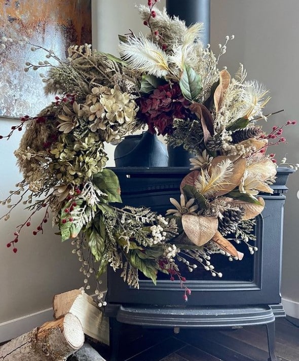 fall wreath by wood stove