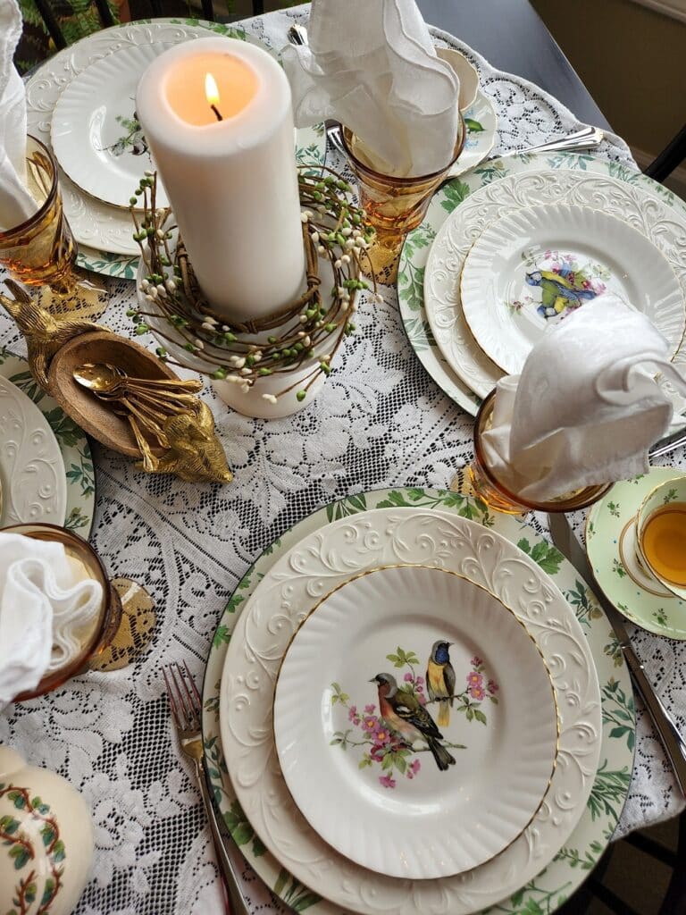antique bird dishes on a table with tablesettings