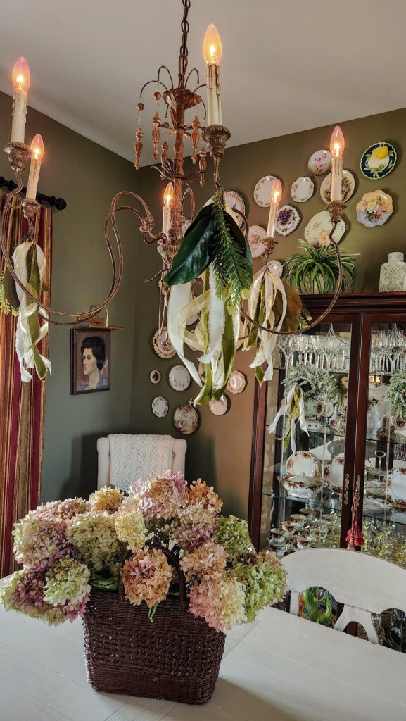 Christmas dining room with chandelier and hanging velvet ribbon from chandelier