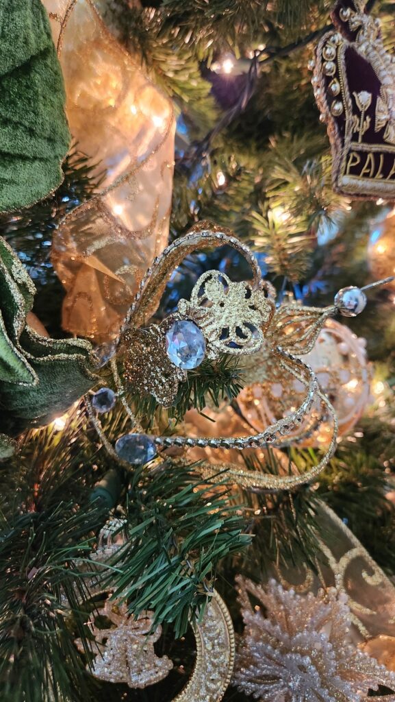gold crown ornament hanging on christmas tree