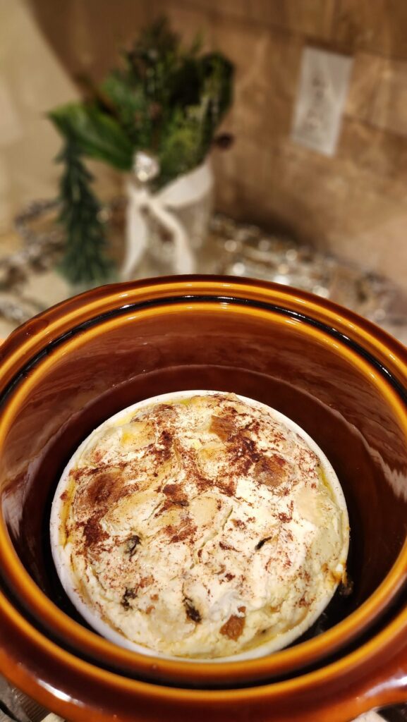 bread pudding in souffle dish inside a crock pot ready to bake