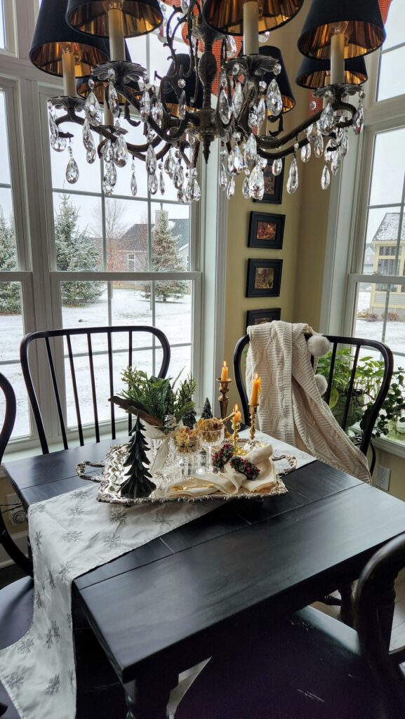 breakfast room with black table and chairs by window