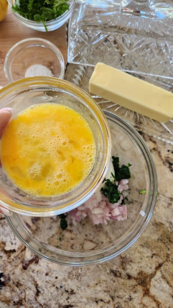 scrambled egg being added to spinach mixture