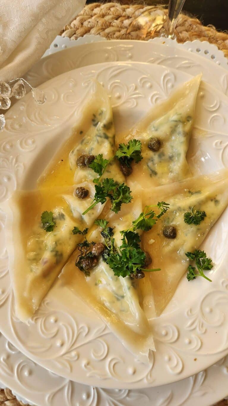 spinach & ricotta ravioli on white dish