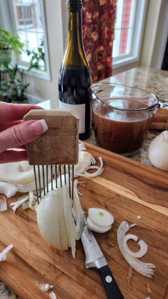 thinly sliced onions on cutting board