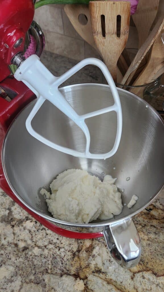 Ricotta cheese in a mixer bowl