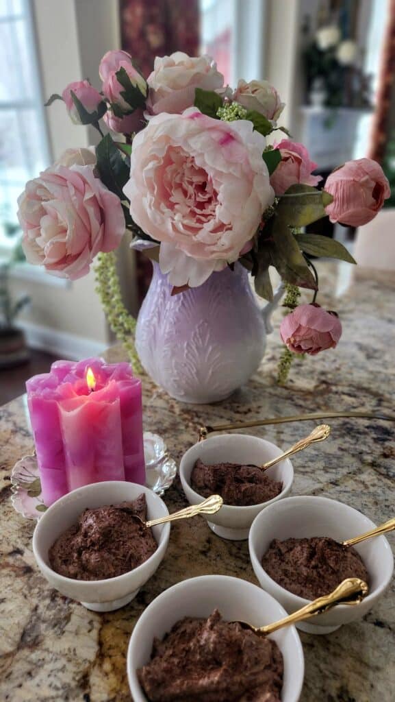 chocolate Ricotta Mousse in cups with pink flowers in a vase
