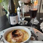 French onion soup in white crock on top of table