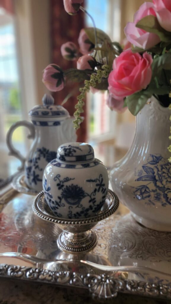 blue and white pottery with pink flowers in pitcher