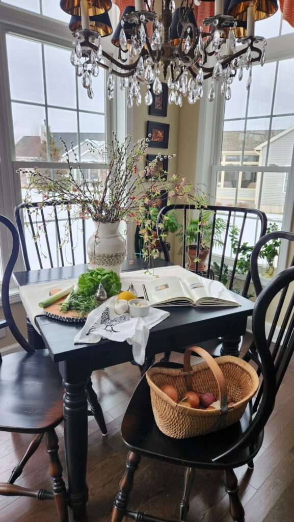 breakfast room table with leeks and ingredients for soup on table