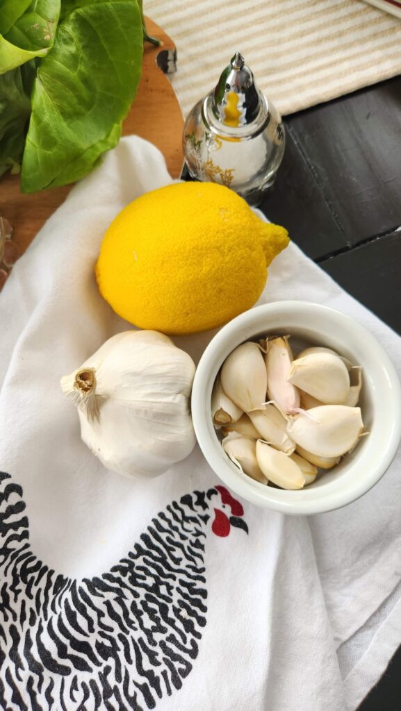 bowl of garlic with lemon on the side