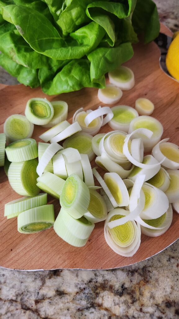 sliced leeks on wood cutting board