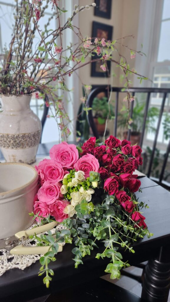 pink country roses and baby roses on table 