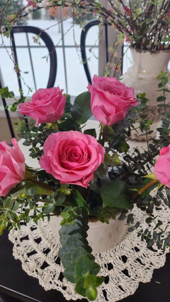 pink roses in a ceramic crock