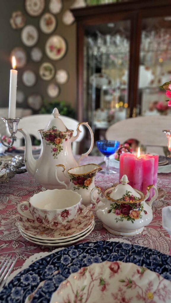 pink chintz dishes on table with pink candle