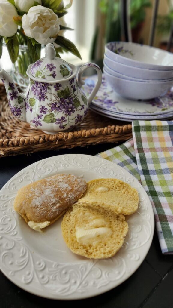 buttermilk scones on plate on table with melted butter on them