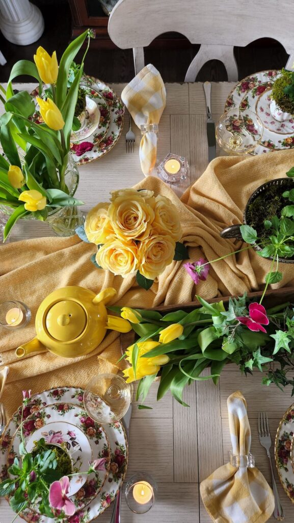 overhead view of flowers on table with yellow teapot