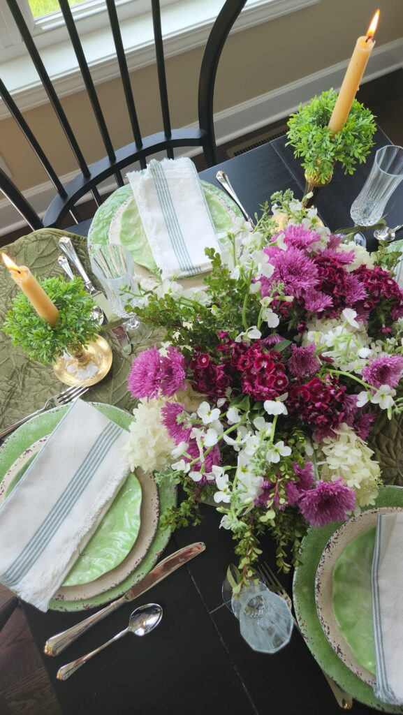 purple green and white flower centerpiece on kitchen table, overhead view