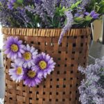 faux lavender flowers with purple daisies on the face of basket