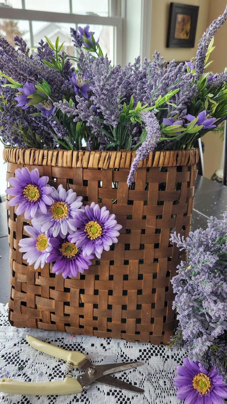 faux lavender flowers with purple daisies on the face of basket