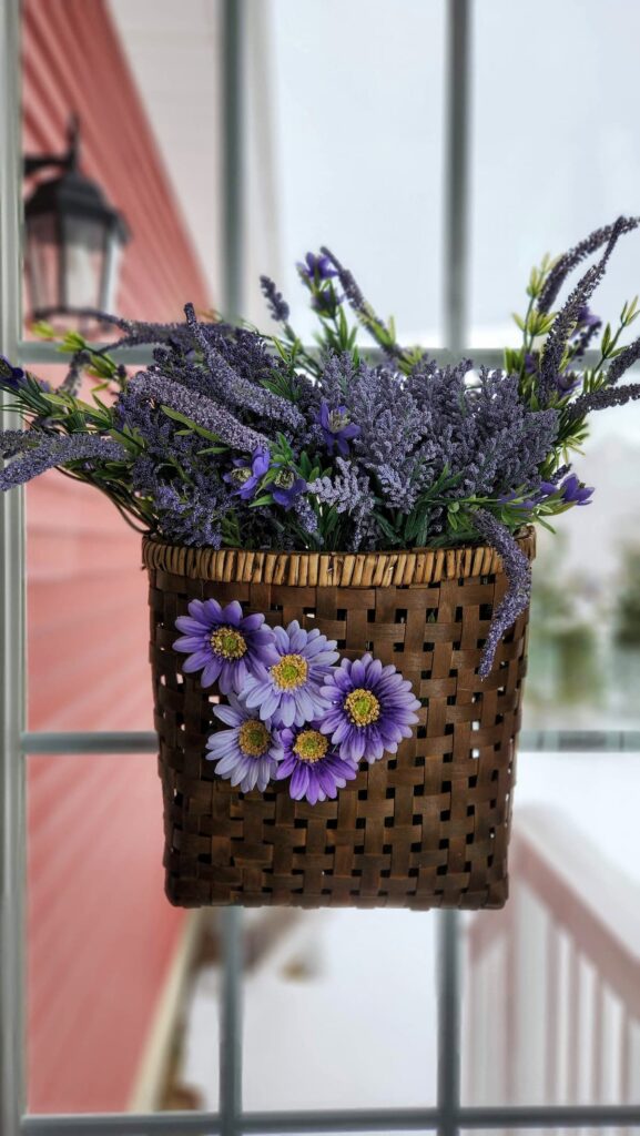 faux lavender flowers in basket hanging on door window