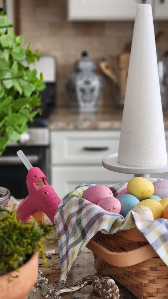 easter eggs in basket with Styrofoam cone on counter
