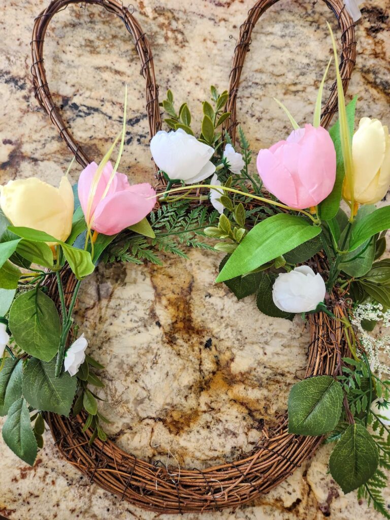 bunny wreath with a few flowers on it