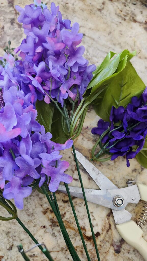purple flowers with cutting tool