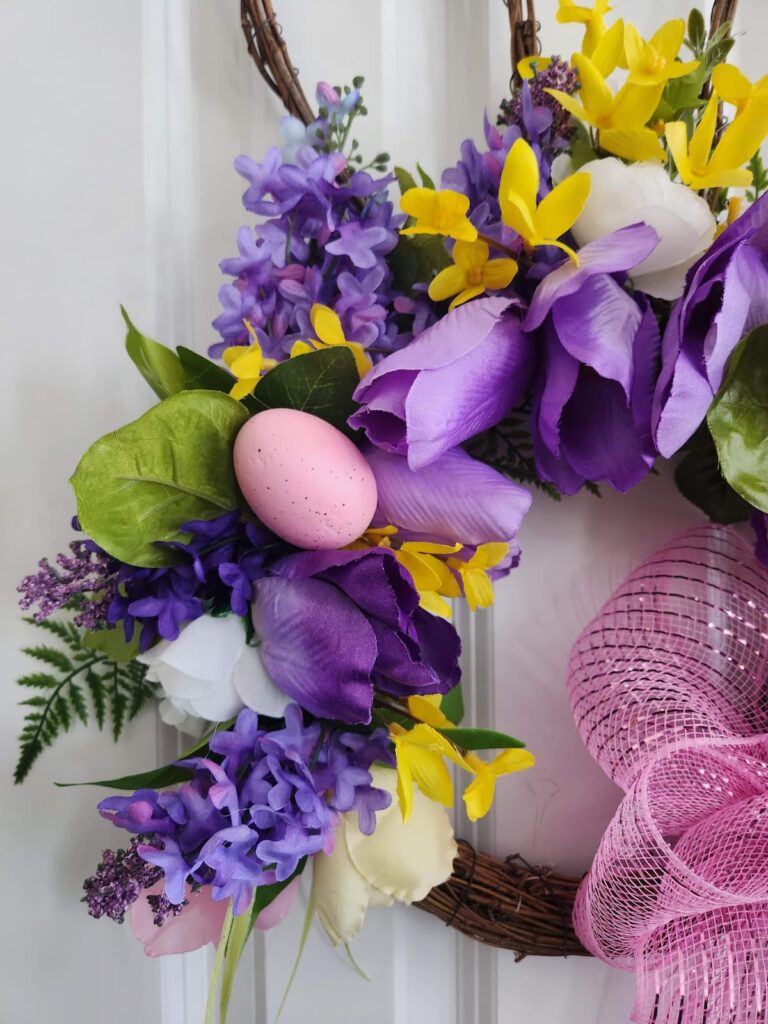 bunny wreath with purple fowers and yellow forsythia added