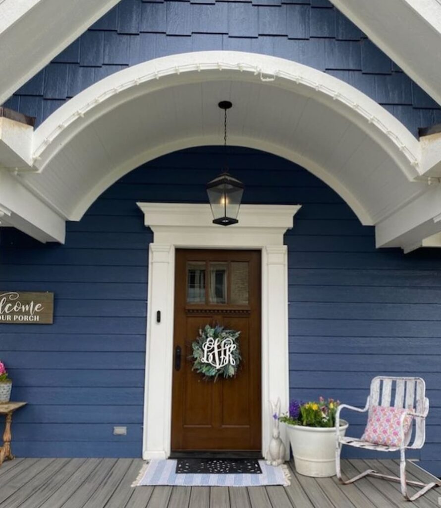 blue home with spring wreath on door