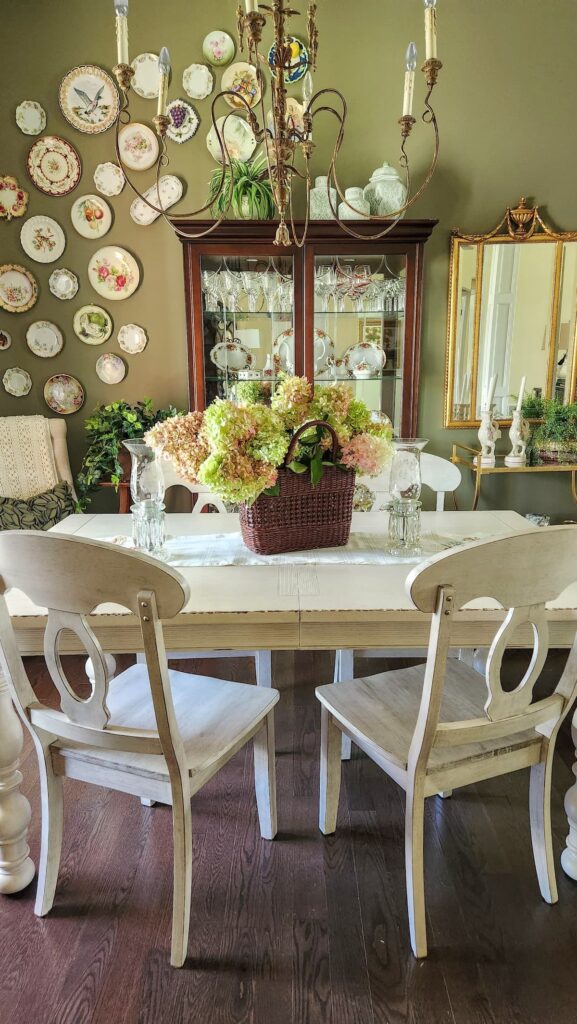 white dining room table with basket of dried hydrangeas in basket on top of table