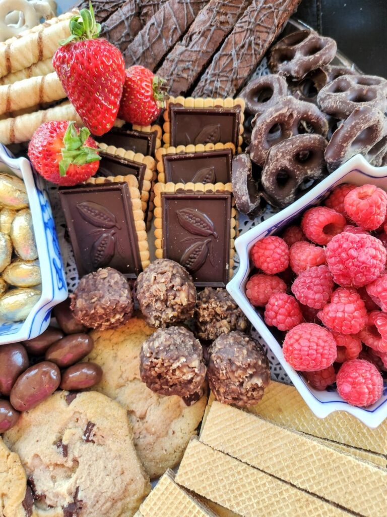 raspberries in dish with cookies and peanut butter butter balls
