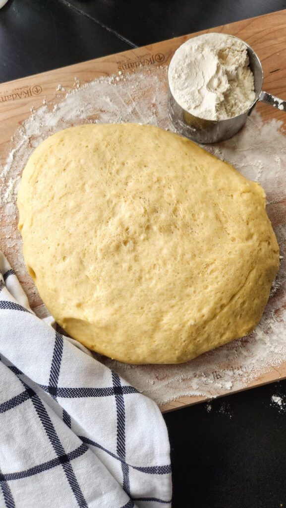 easter break dough on floured board waiting to rise