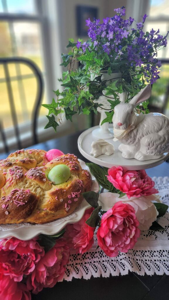 easter bread on table with white bunny and pink flowers