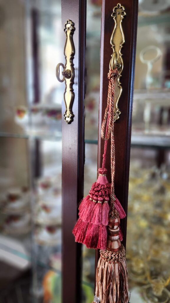 burgundy tassels hanging from dining room hutch door handle