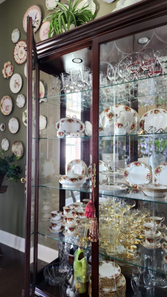 dining room hutch with glass doors and shelf with fine china inside