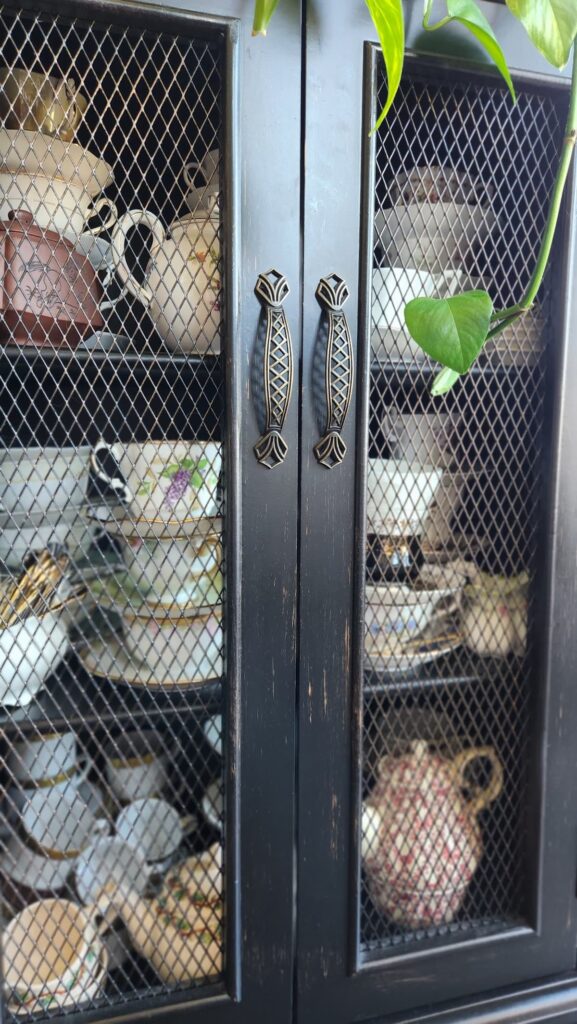 small black china cabinet with mesh doors