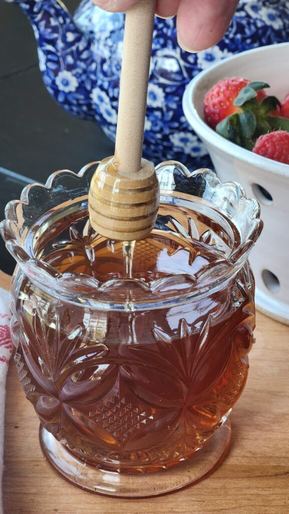 crystal honey pot with honey dipper over the top