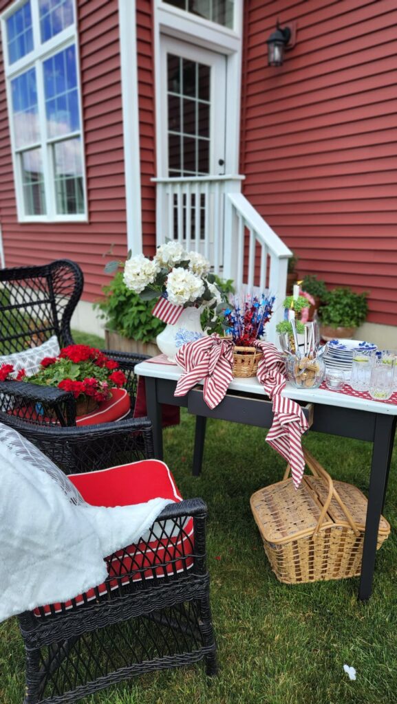 outdoor table with black wicker chairs decorated for memorial day 