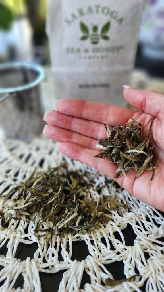 ladies hand holding loose tea in her palm