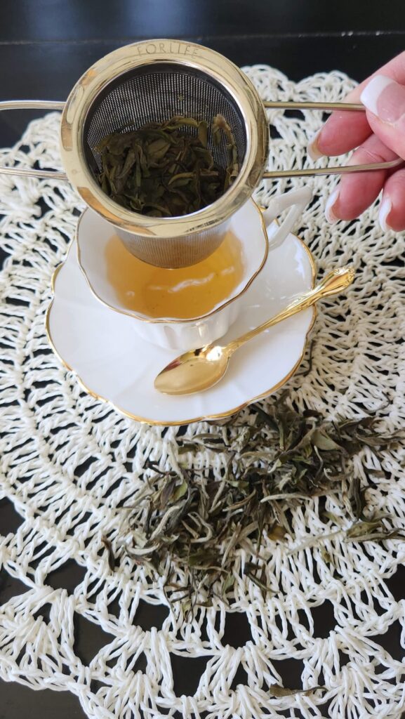 tea strainer being taken out of tea cup