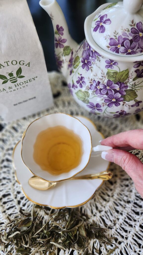 white tea cup on table with tea in it