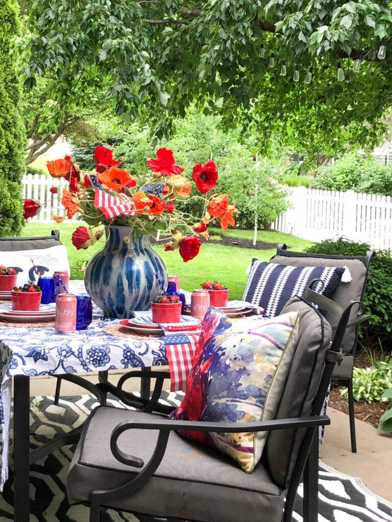 outdoor patio table with red white and blue table setting for the 4th of July