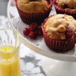 cranberry walnut muffins on a white pedestal dish